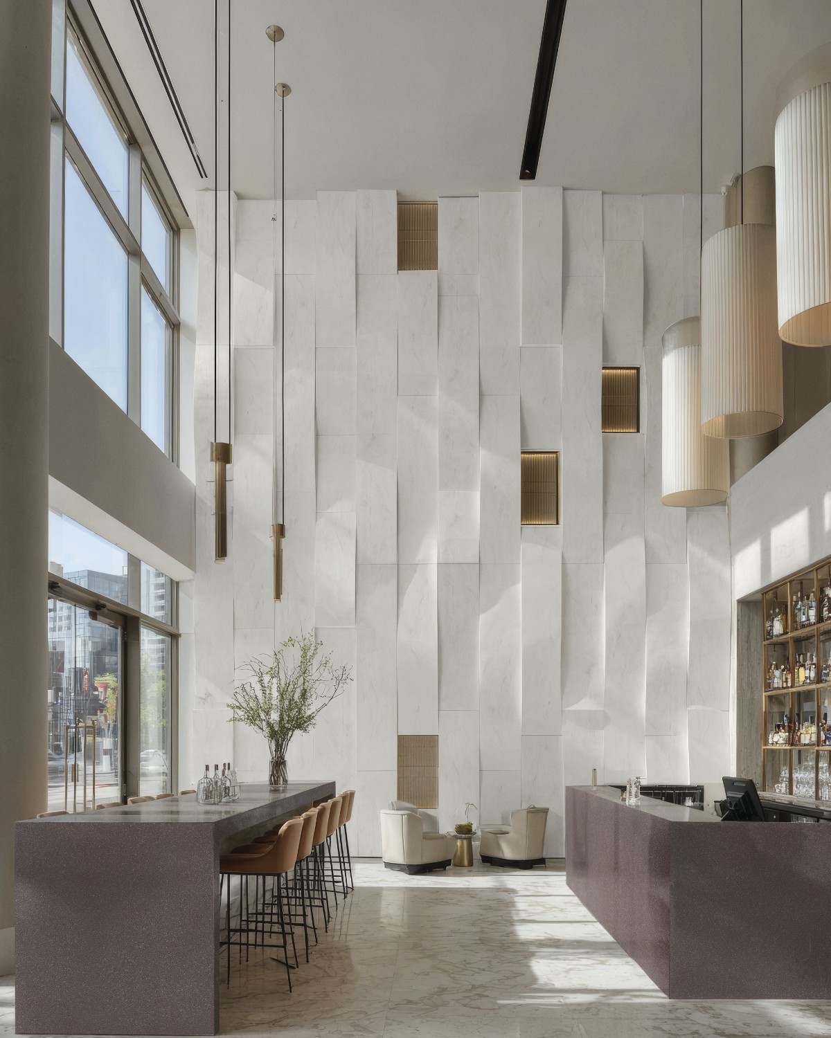 Εσωτερικός χώρος lobby με πάγκους Corian® City Roast σε βαθύ καφέ τόνο και σύγχρονο αρχιτεκτονικό σχεδιασμό